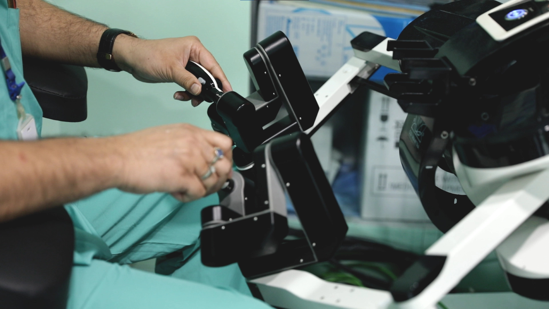 Surgeon controlling robotic surgery console during gynaecological procedure